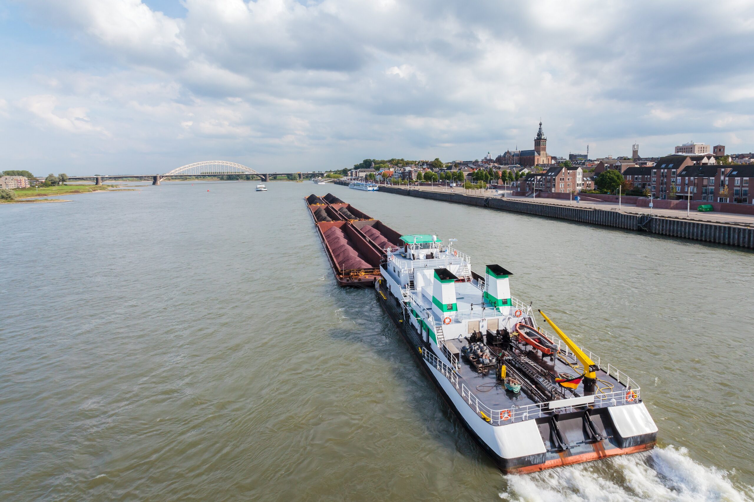 Cargo riverboat passing the Dutch city Nijmegen